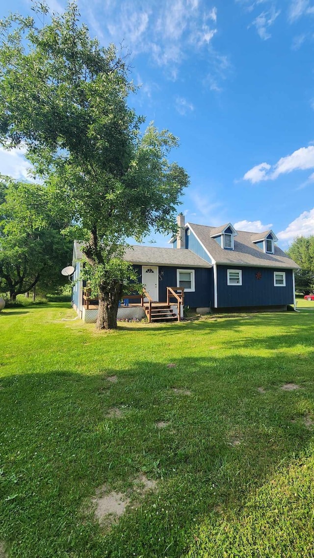 back of property with a lawn