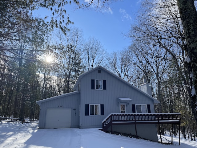 view of front of home featuring a garage and a wooden deck