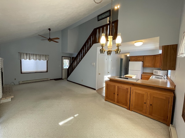 kitchen featuring a brick fireplace, a baseboard radiator, white appliances, lofted ceiling, and hanging light fixtures