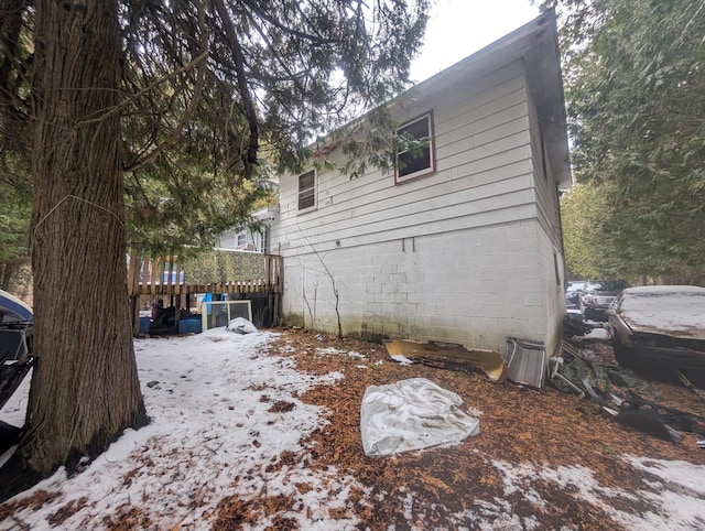 snow covered property featuring a deck