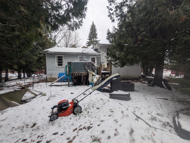 view of snow covered back of property