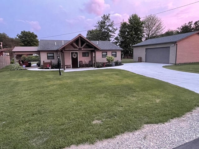 view of front of house with a yard, an outdoor structure, and a garage