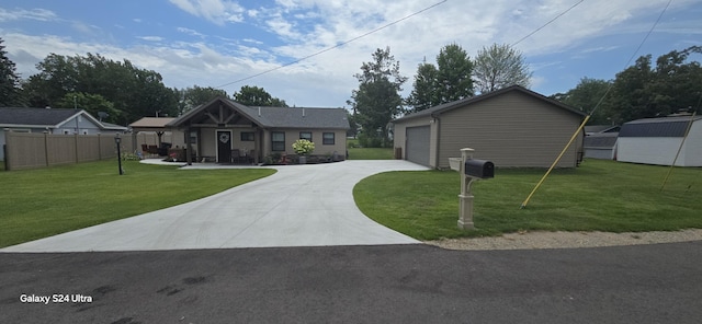 view of front facade with a garage, a front yard, and an outbuilding