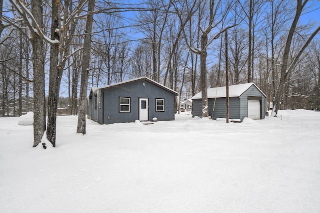 exterior space featuring a garage and an outbuilding