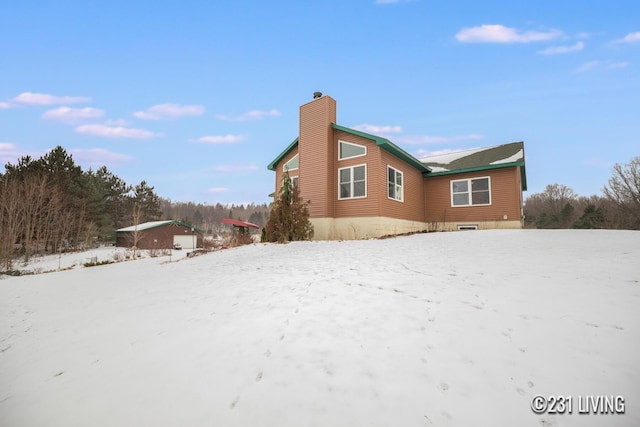 view of snowy exterior with a garage