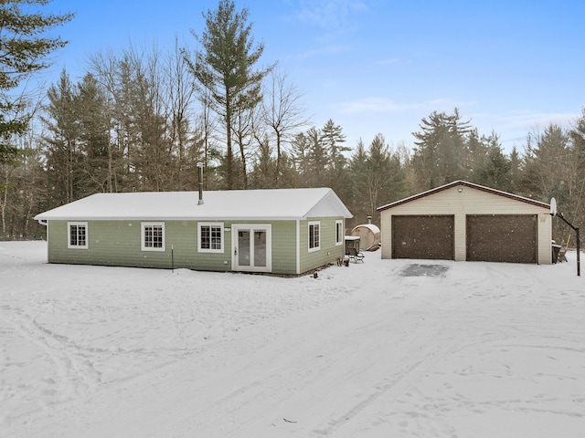 view of front of property with a garage and an outbuilding