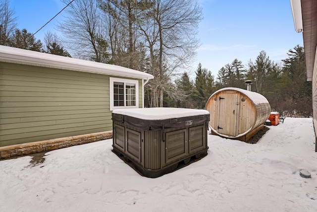 snowy yard featuring a hot tub