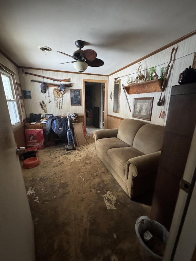 living room with ceiling fan, ornamental molding, and wood walls