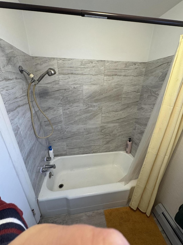 bathroom featuring shower / bath combo with shower curtain and a baseboard radiator