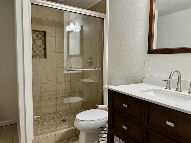 bathroom with an enclosed shower, vanity, toilet, and tile patterned flooring