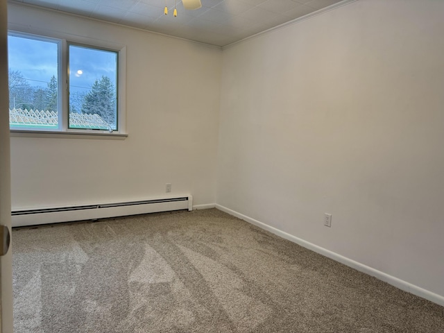 spare room with carpet floors, baseboard heating, ornamental molding, and ceiling fan