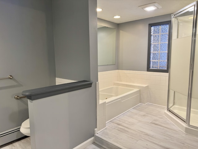 bathroom featuring toilet, wood-type flooring, plus walk in shower, and a baseboard radiator