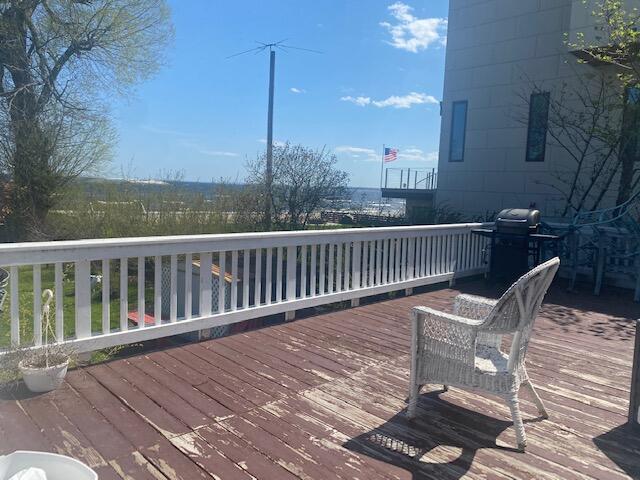 wooden terrace with area for grilling