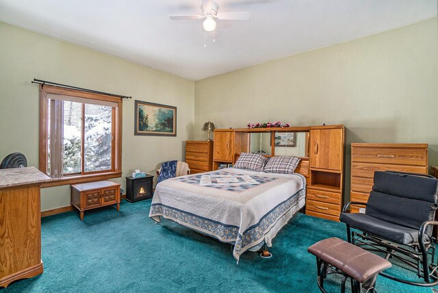 carpeted bedroom featuring ceiling fan and access to exterior