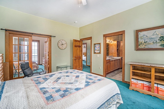 bedroom with ceiling fan, ensuite bath, and light carpet