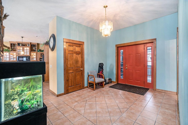 foyer entrance featuring an inviting chandelier and light tile patterned floors