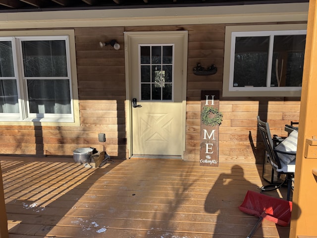 view of exterior entry with a deck