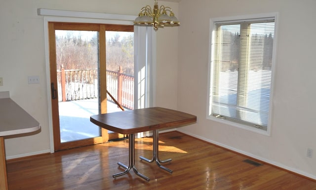 dining room with an inviting chandelier and hardwood / wood-style floors