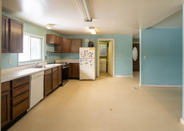 kitchen featuring white appliances and sink