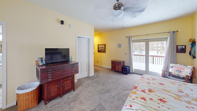 bedroom with ceiling fan, access to exterior, light colored carpet, and a closet