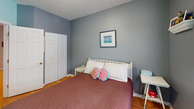 bedroom featuring hardwood / wood-style flooring and a closet