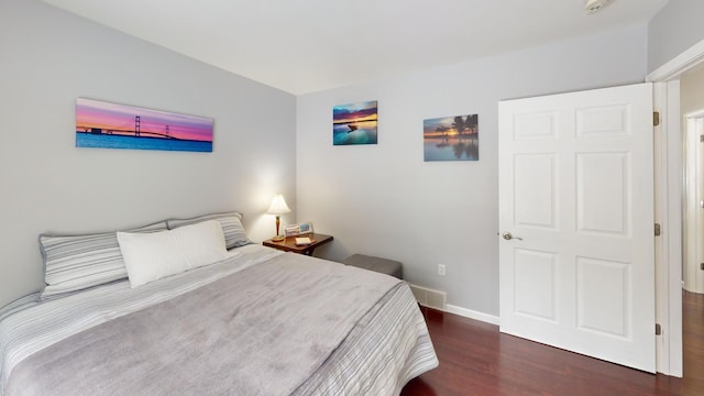 bedroom with dark wood-type flooring