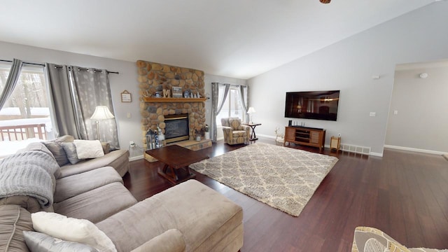 living room with a fireplace, vaulted ceiling, and dark hardwood / wood-style floors