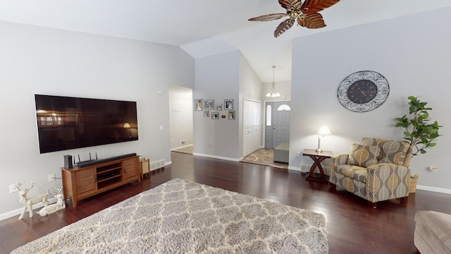 living room featuring lofted ceiling, dark hardwood / wood-style flooring, and ceiling fan with notable chandelier