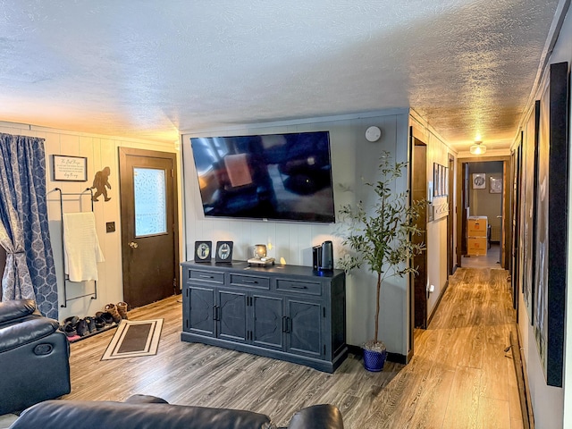 living room with a textured ceiling and light hardwood / wood-style flooring