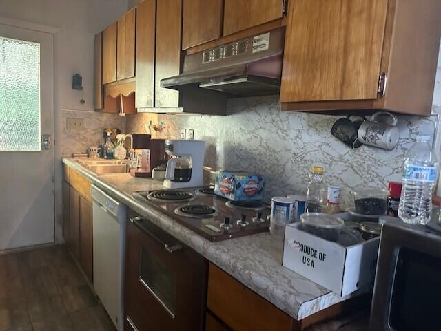 kitchen with tasteful backsplash, oven, dishwasher, and black cooktop