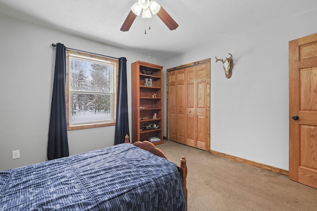 carpeted bedroom featuring ceiling fan and a closet