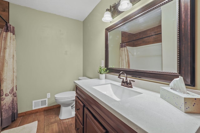 bathroom with hardwood / wood-style flooring, vanity, toilet, and a shower with curtain