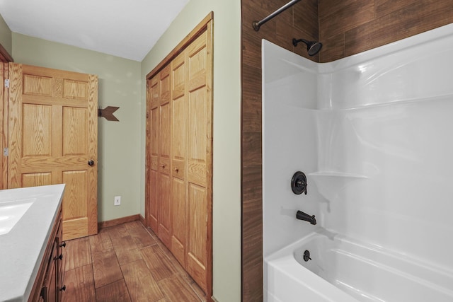 bathroom with vanity, wood-type flooring, and washtub / shower combination