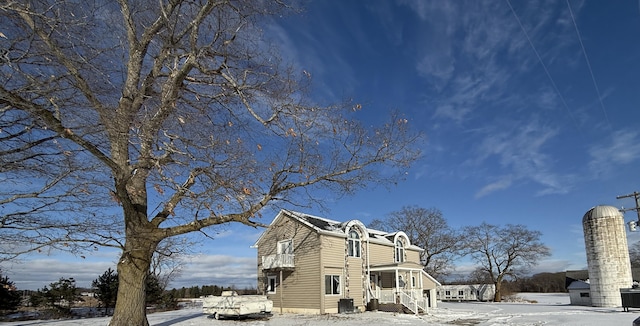 snow covered property featuring central air condition unit