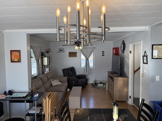 living room featuring crown molding, ceiling fan, and hardwood / wood-style flooring