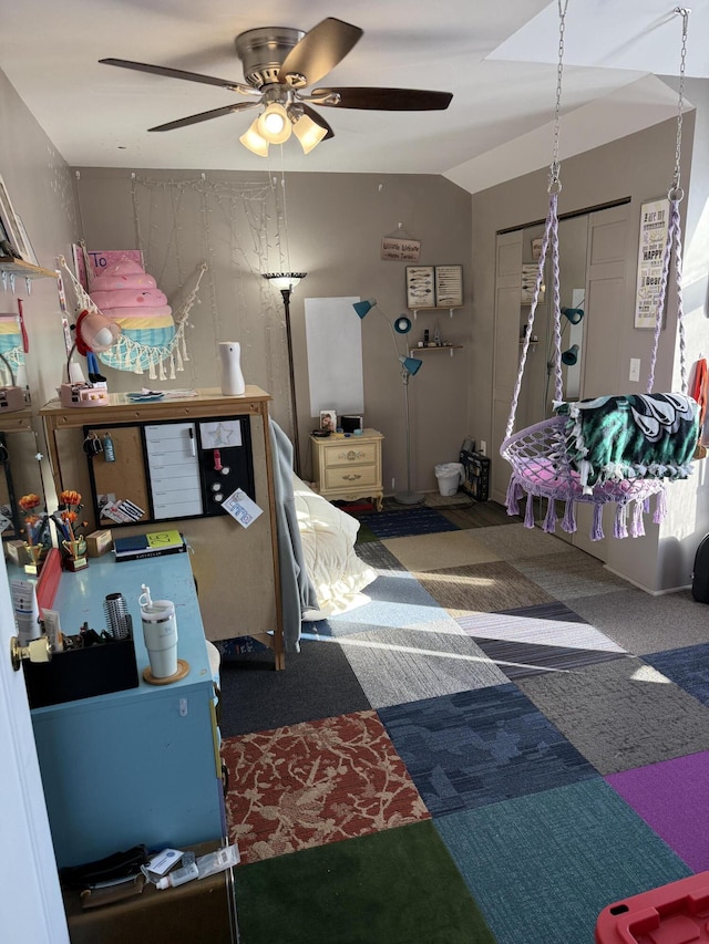 carpeted bedroom featuring vaulted ceiling, a closet, and ceiling fan