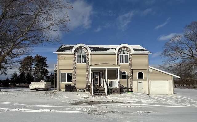 view of front of property featuring a garage, a porch, and central AC unit