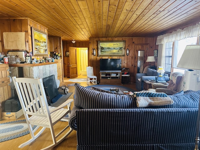 living room with wooden ceiling, a fireplace, and wood walls