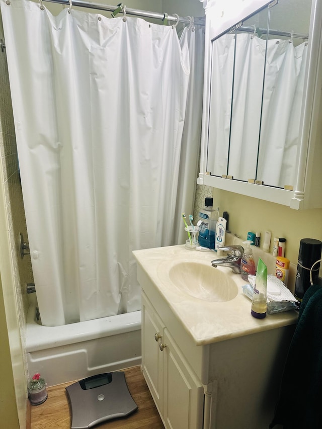 bathroom featuring vanity, hardwood / wood-style floors, and shower / bathtub combination with curtain