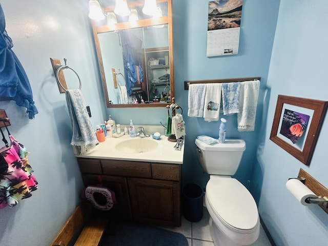 bathroom featuring vanity, toilet, and tile patterned flooring