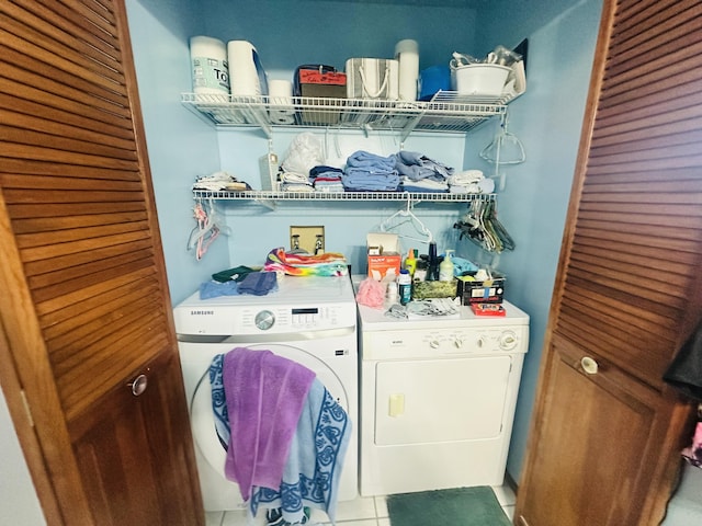 washroom with washing machine and dryer and tile patterned floors