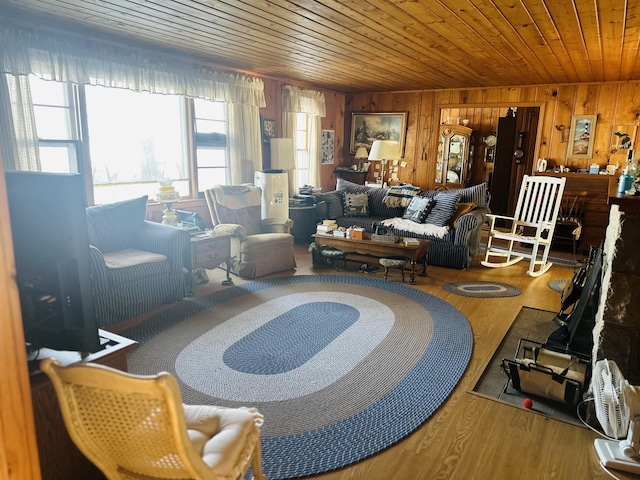 living room with wood-type flooring, wooden walls, and wood ceiling