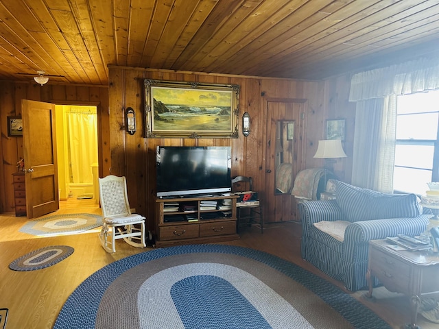 living room with wood ceiling and wooden walls