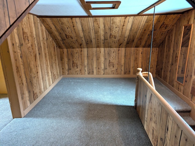 additional living space featuring wood ceiling, vaulted ceiling, wood walls, and carpet flooring