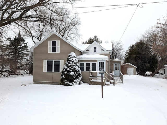 view of front of house featuring a storage unit