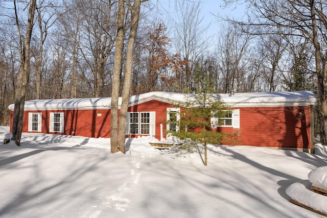 view of snow covered back of property