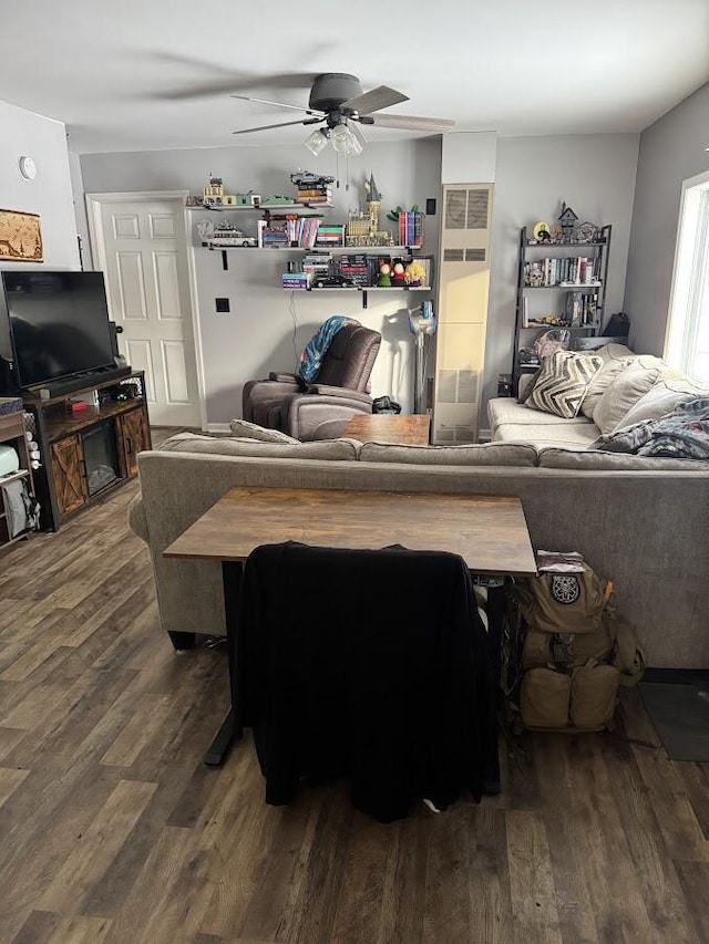 living room with hardwood / wood-style flooring and ceiling fan