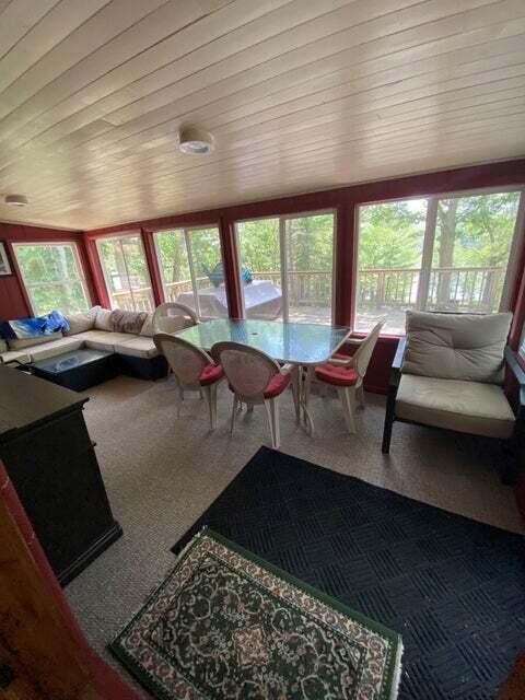 living room with plenty of natural light and wooden ceiling