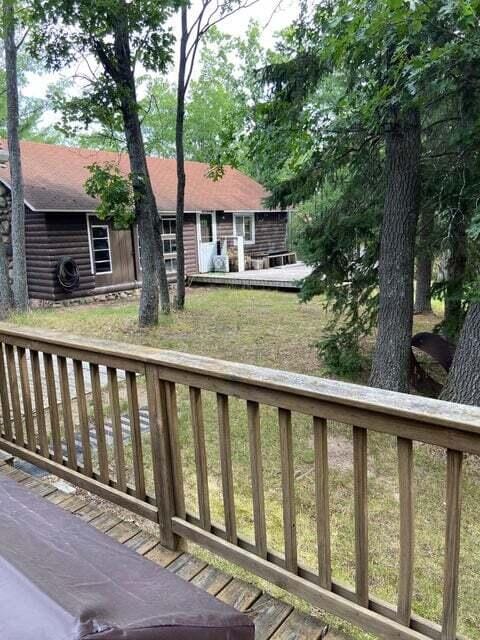 wooden terrace with a lawn