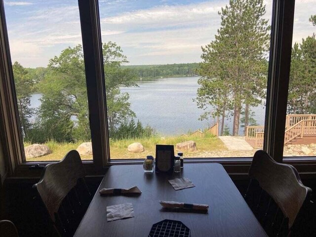 interior space with a water view and a healthy amount of sunlight